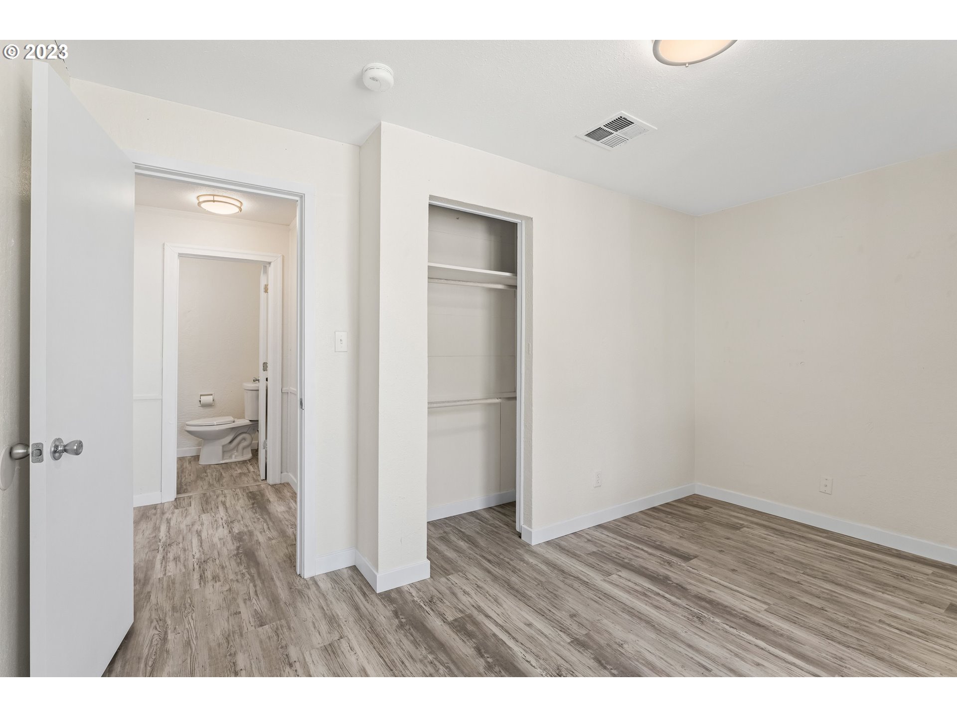 835 L Street Springfield, OR 97477 - Photo 27 of 40 a view of an empty room with wooden floor