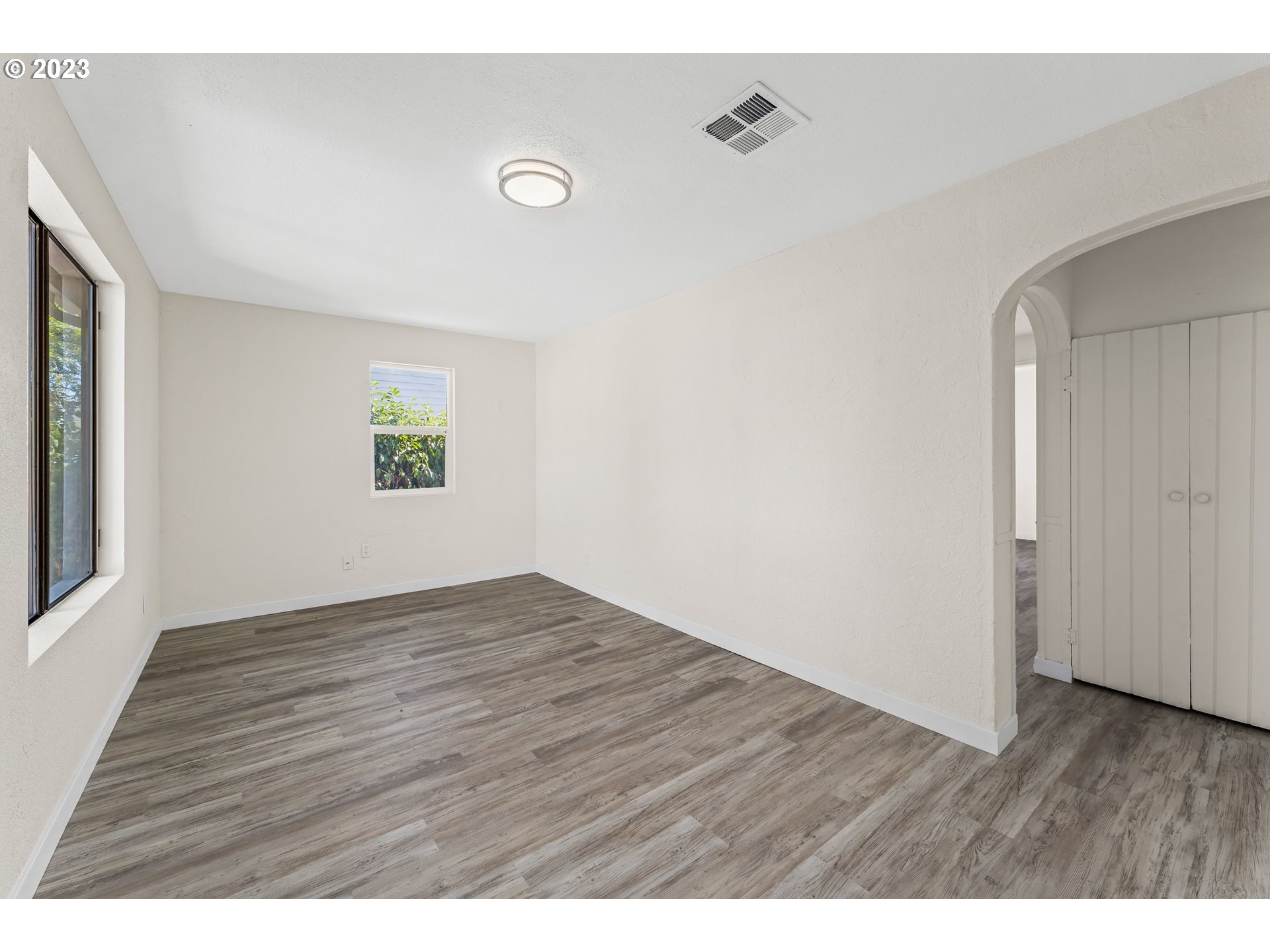835 L Street Springfield, OR 97477 - Photo 6 of 40 a view of an empty room with wooden floor and a window