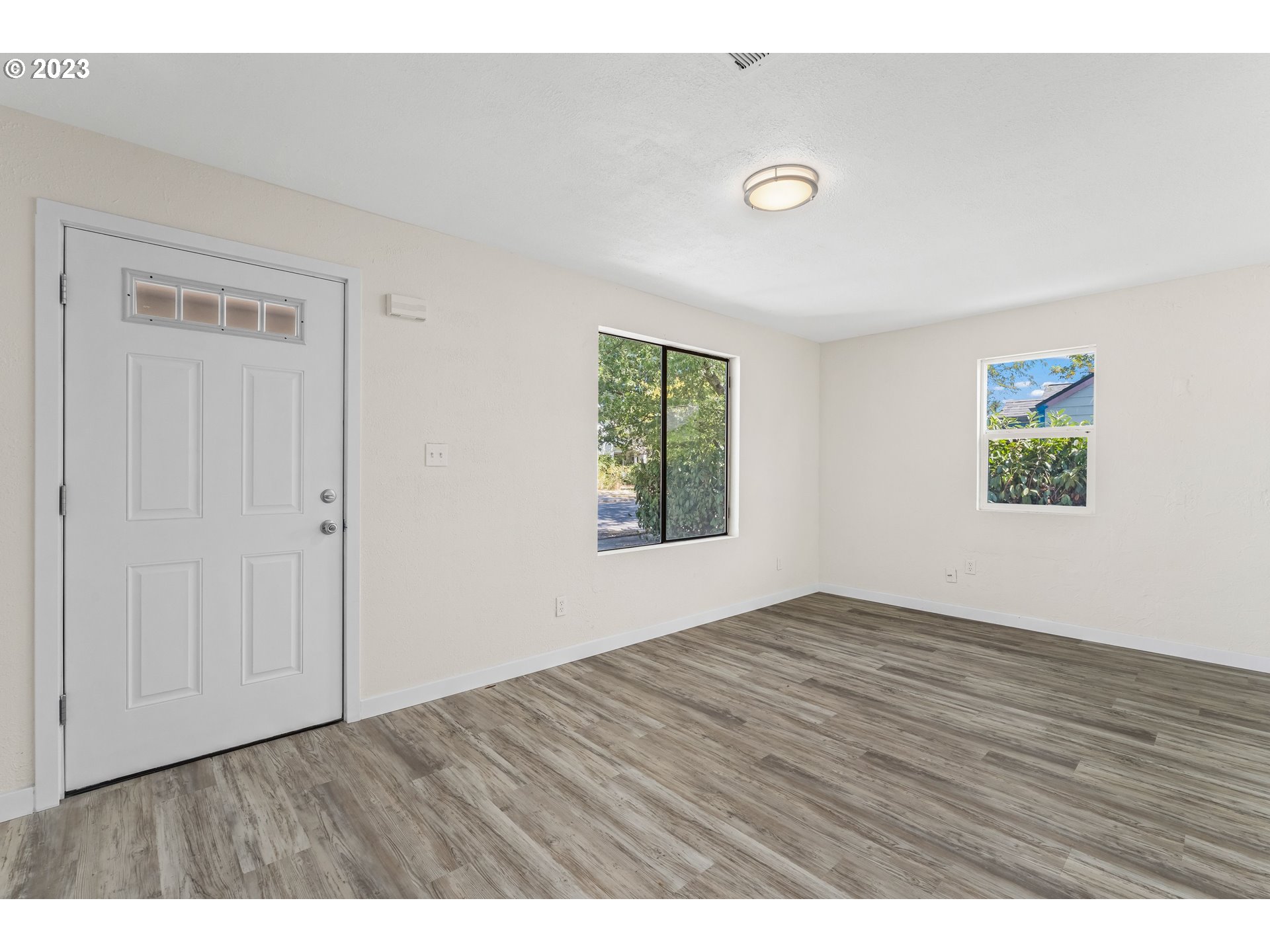 835 L Street Springfield, OR 97477 - Photo 8 of 40 a view of an empty room with window and wooden floor
