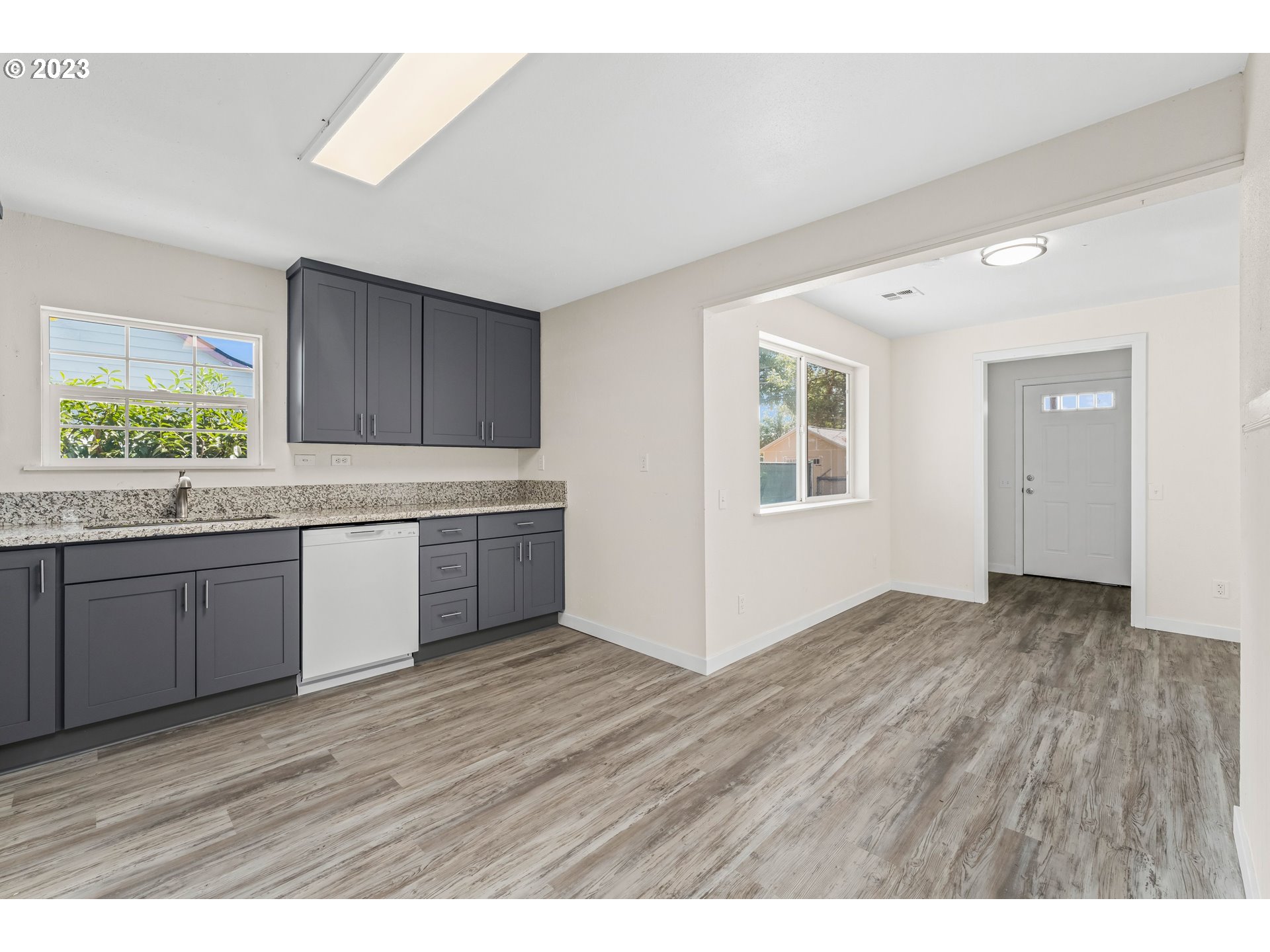 835 L Street Springfield, OR 97477 - Photo 9 of 40 a view of a kitchen with a sink dishwasher and wooden floor
