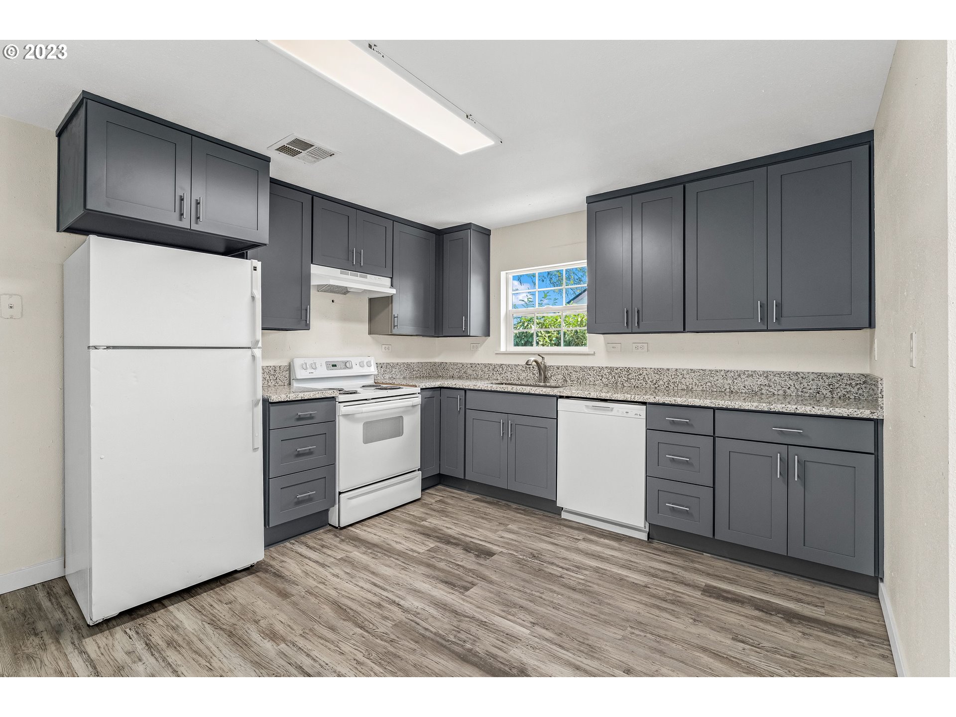 835 L Street Springfield, OR 97477 - Photo 10 of 40 a kitchen with a refrigerator sink and cabinets