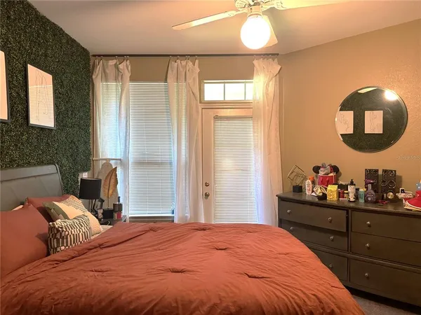 a bedroom with a bed and a mirror