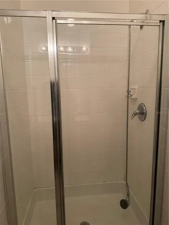 a bathroom with a glass shower door