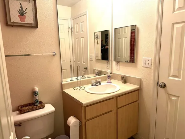 a bathroom with a sink toilet and mirror