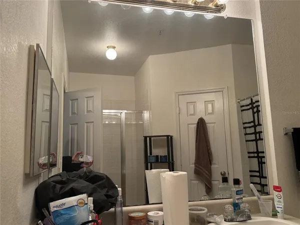 a bathroom with double vanity and a mirror
