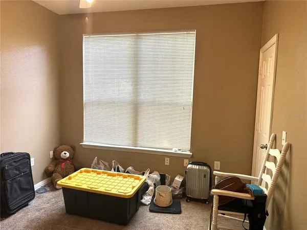 a room with furniture and two windows