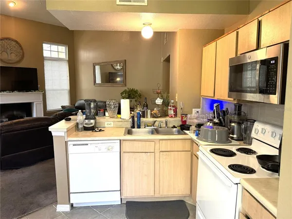 a kitchen with a sink and a stove top oven