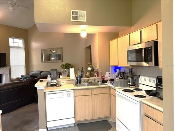 a kitchen with a sink stove and microwave