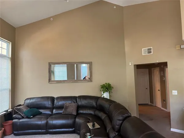 a living room with furniture a couch and potted plant