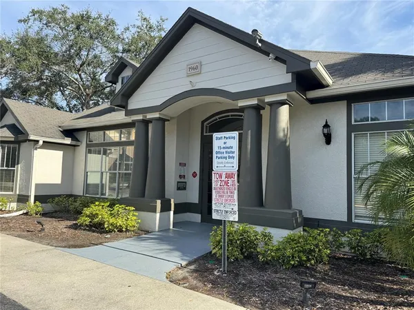 a view of a house with potted plants