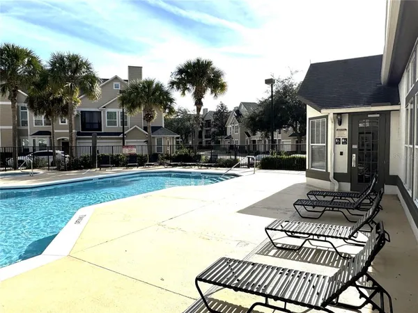 a swimming pool with outdoor seating and yard