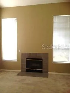 a view of empty room with a fireplace