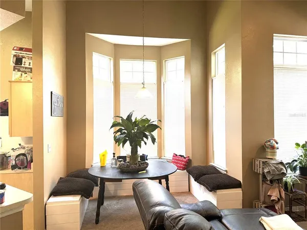 a living room with furniture and large windows