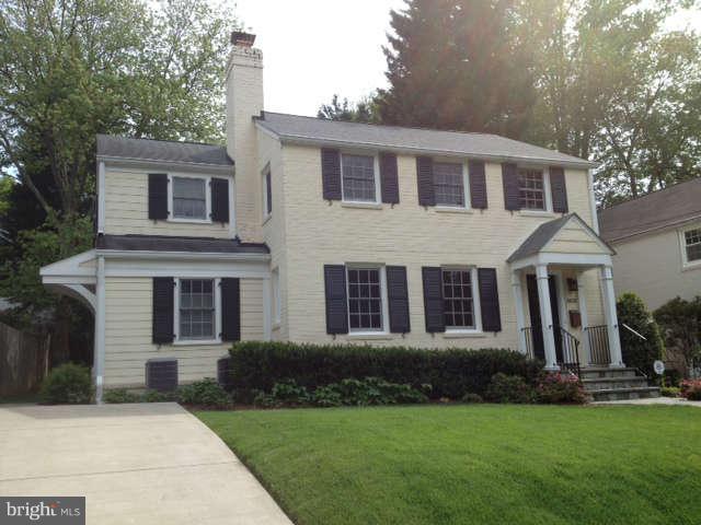 8818 Ridge Road Bethesda, MD 20817 - Photo 1 of 2 a front view of a house with a garden and yard