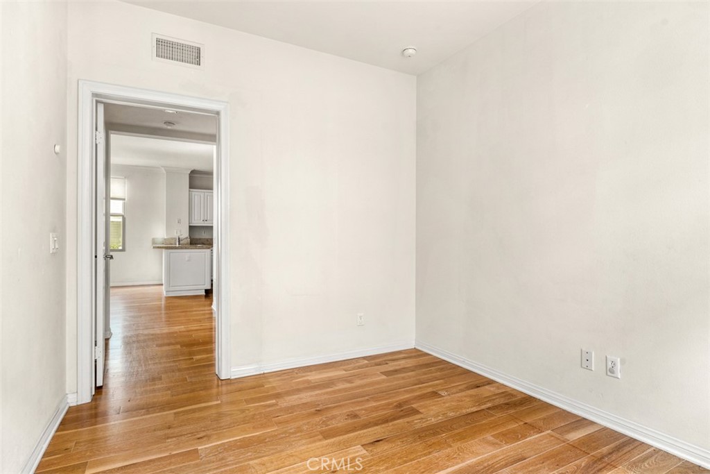 32 Serenity Irvine, CA 92618 - Photo 12 of 34 a view of a hallway with wooden floor and a bathroom