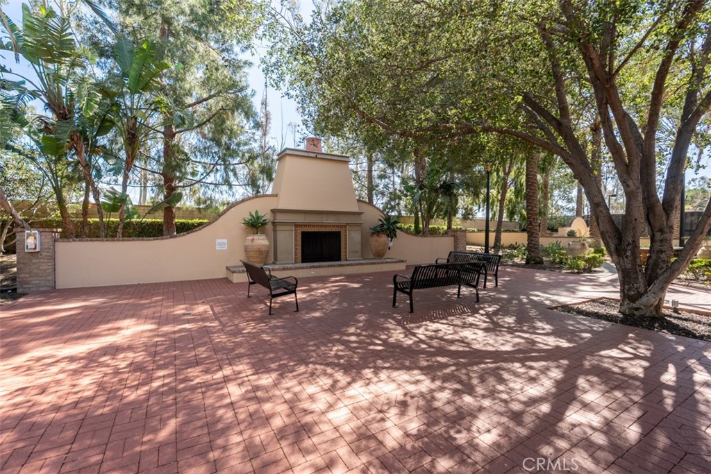 32 Serenity Irvine, CA 92618 - Photo 21 of 34 a view of backyard with a table and chair a barbeque and a large trees