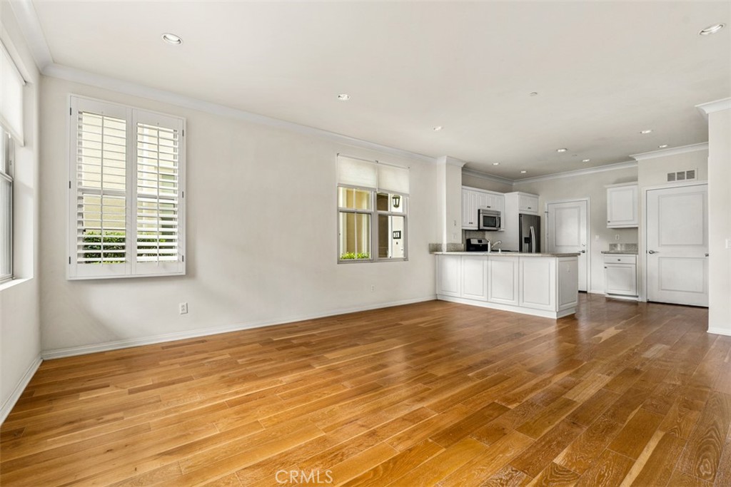 32 Serenity Irvine, CA 92618 - Photo 3 of 34 a view of empty room with wooden floor and kitchen