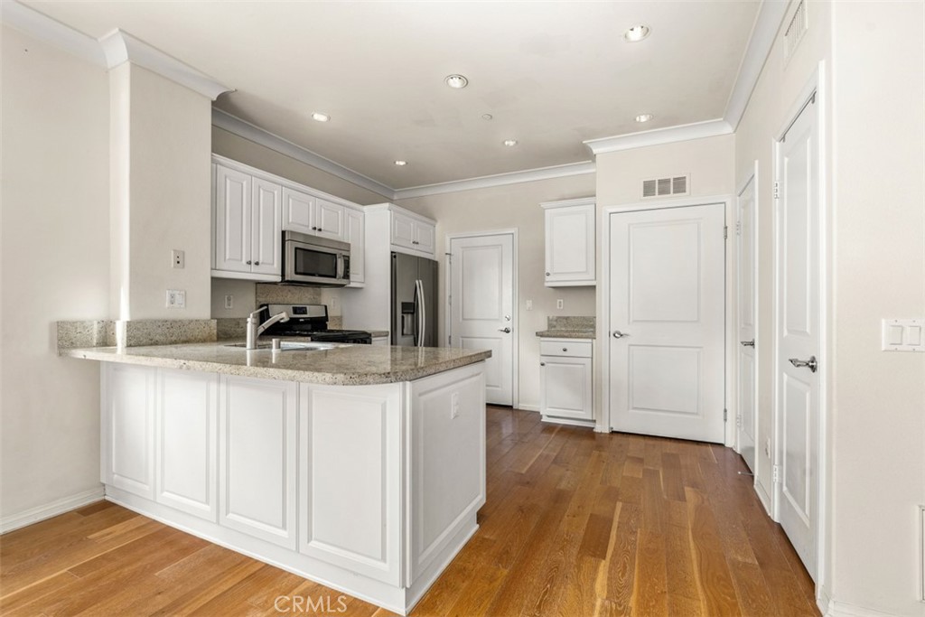 32 Serenity Irvine, CA 92618 - Photo 6 of 34 a kitchen with stainless steel appliances granite countertop a refrigerator and a stove top oven