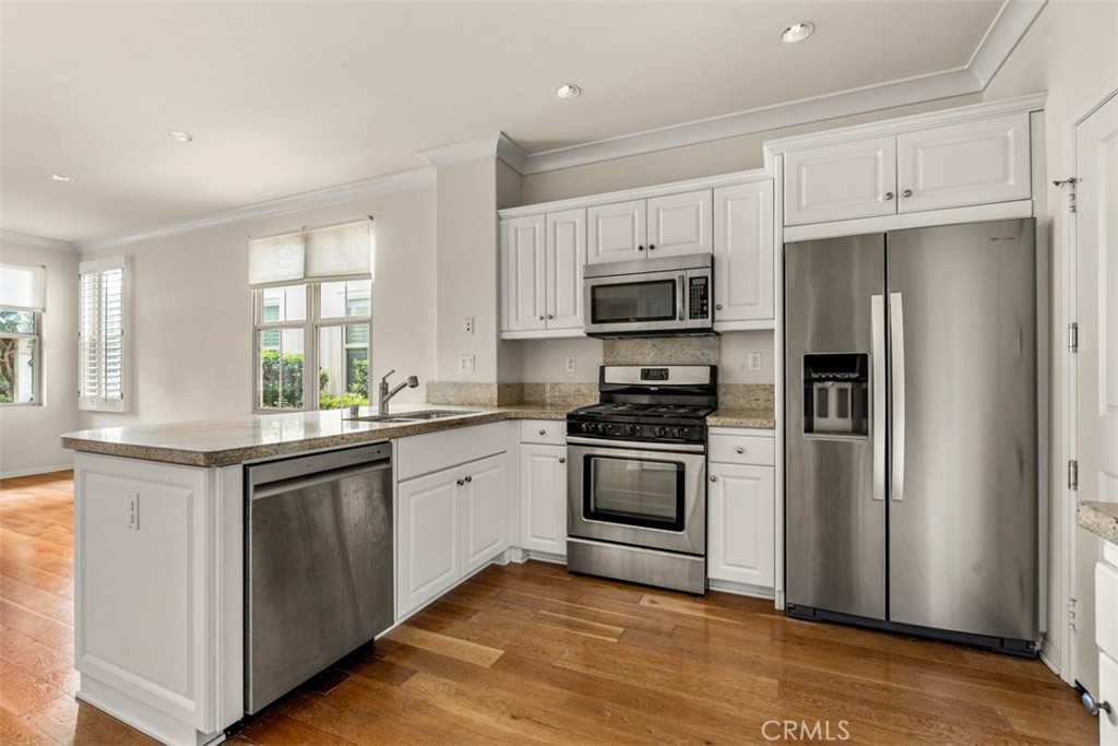 32 Serenity Irvine, CA 92618 - Photo 7 of 34 a kitchen with stainless steel appliances granite countertop a refrigerator stove and sink