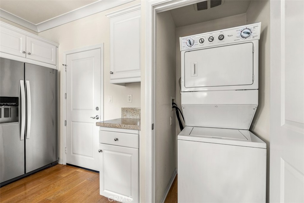 32 Serenity Irvine, CA 92618 - Photo 8 of 34 a view of washer and dryer with wooden floor