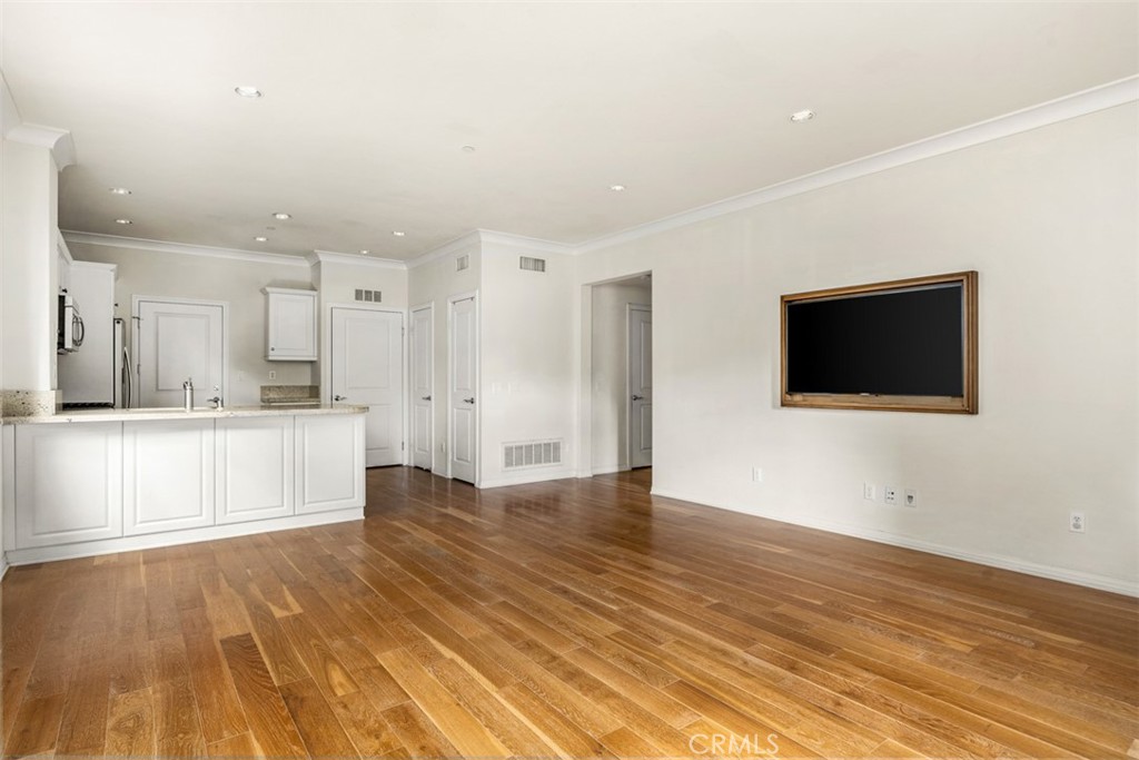 32 Serenity Irvine, CA 92618 - Photo 10 of 34 a view of an empty room with wooden floor and a kitchen