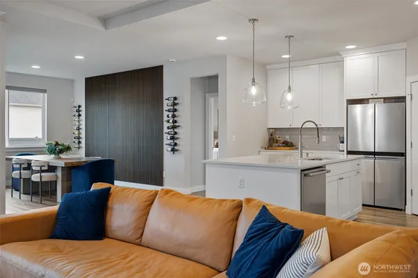 a living room with stainless steel appliances kitchen island granite countertop furniture and a view of living room