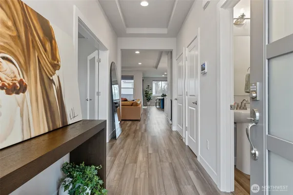 a view of a hallway with wooden floor and staircase