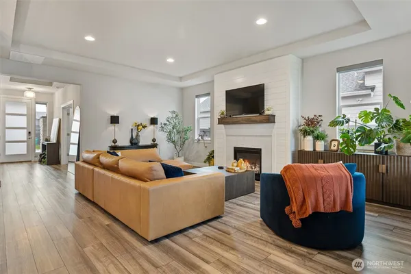 a living room with furniture a flat screen tv and a fireplace