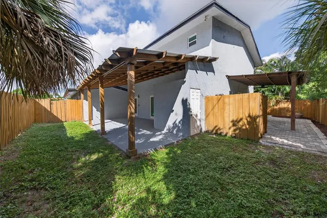 a kitchen with stainless steel appliances granite countertop a stove top oven a sink dishwasher and white cabinets with wooden floor