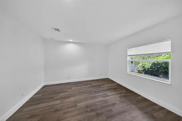 an aerial view of residential building with parking and yard