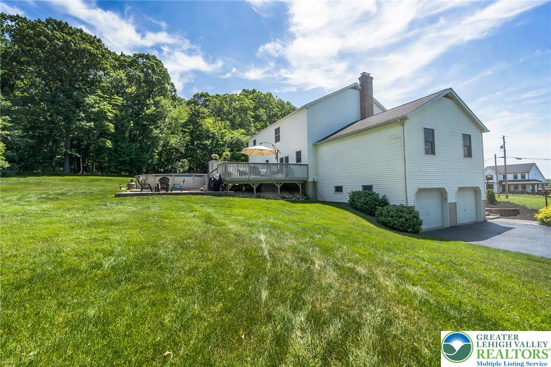 9461 Red Road Kempton, PA 19529 - Photo 49 of 55 A spacious backyard with an above-ground pool and deck awaits outdoor enjoyment.