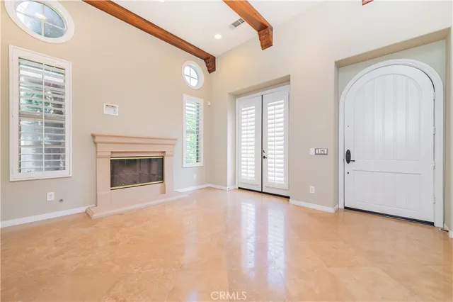 an empty room with windows dryer and fireplace