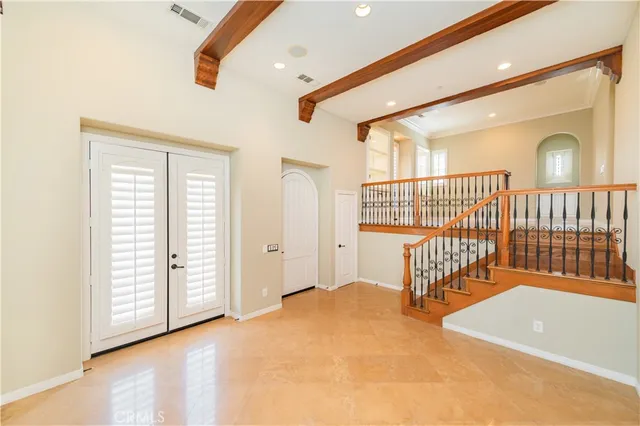 a view of a hallway with wooden floor and a potted plant