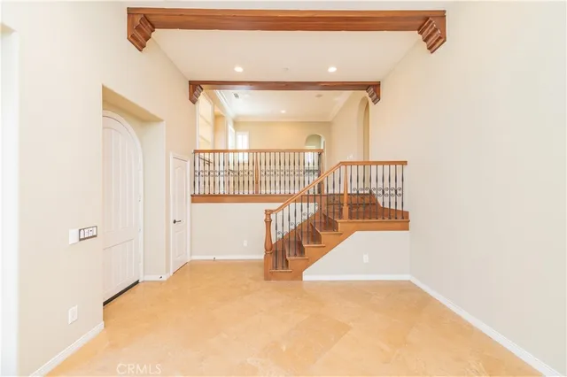 an empty room with windows and cabinet