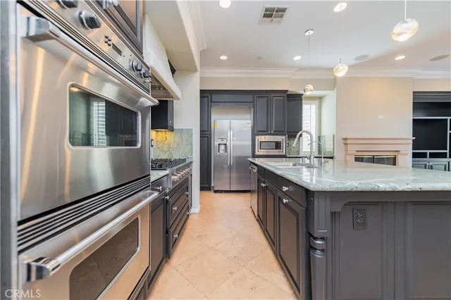 a kitchen with a sink cabinets and wooden floor