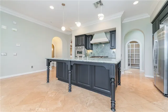 an empty room with windows and fireplace