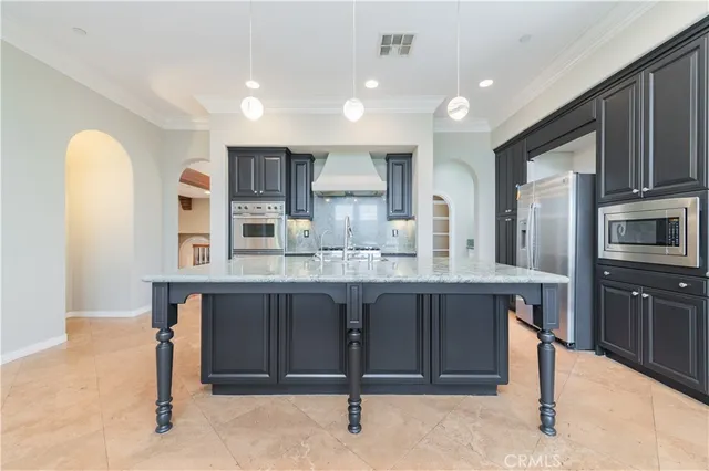 a large kitchen with cabinets and stainless steel appliances