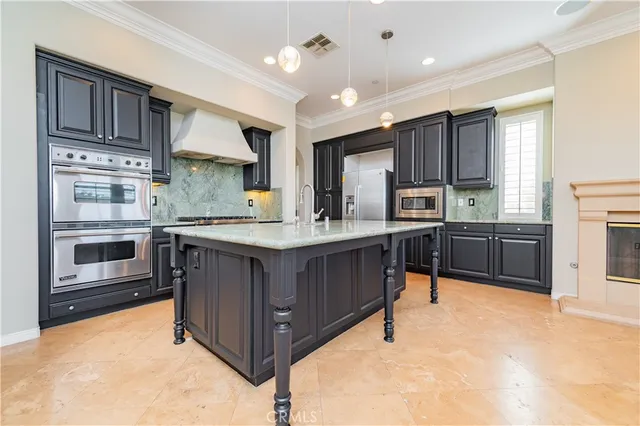 an empty room with kitchen view and a window