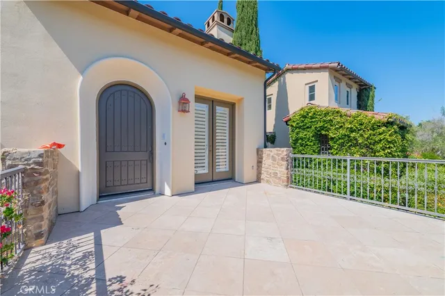 a view of a house with wooden fence next to a yard