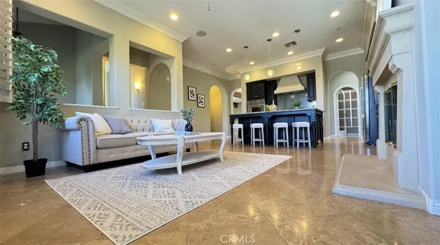 a living room with furniture a dining table and a potted plant