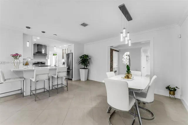 a view of a dining room with furniture and chandelier