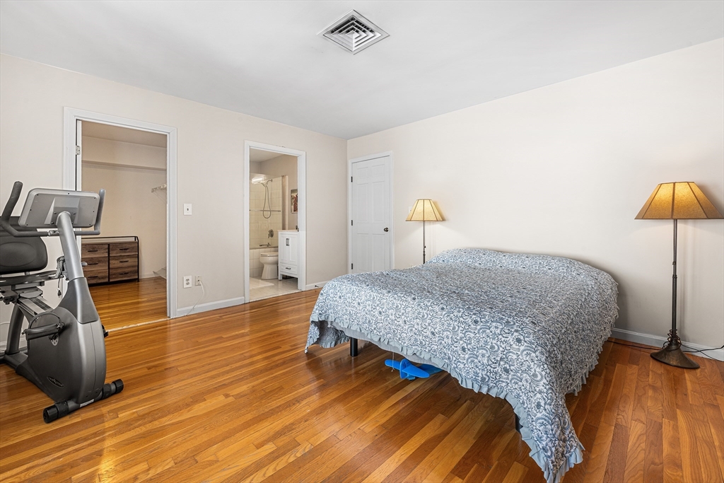 63 Garden Road, Unit C5 Wellesley, MA 02481 - Photo 15 of 30 a bedroom with a bed and wooden floor