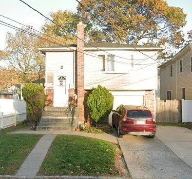 a view of a car parked in front of a house