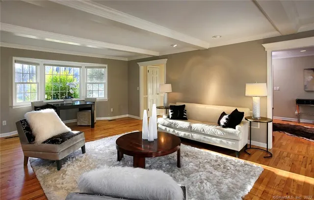 a living room with furniture lamp and window