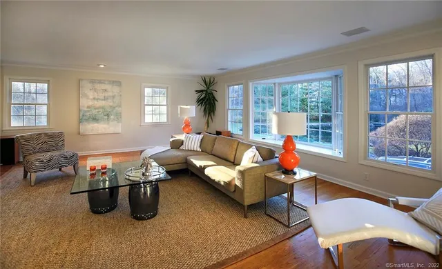 a living room with furniture and a large window