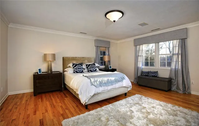 a spacious bedroom with a bed and a large window