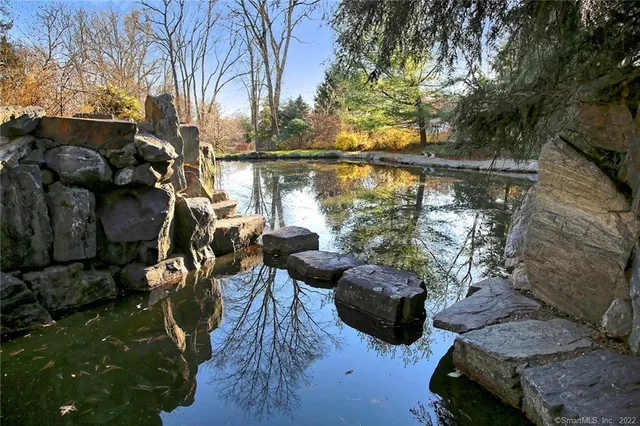 a view of a balcony with chairs and a potted plant