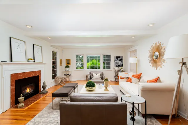 a living room with furniture a fireplace and a table