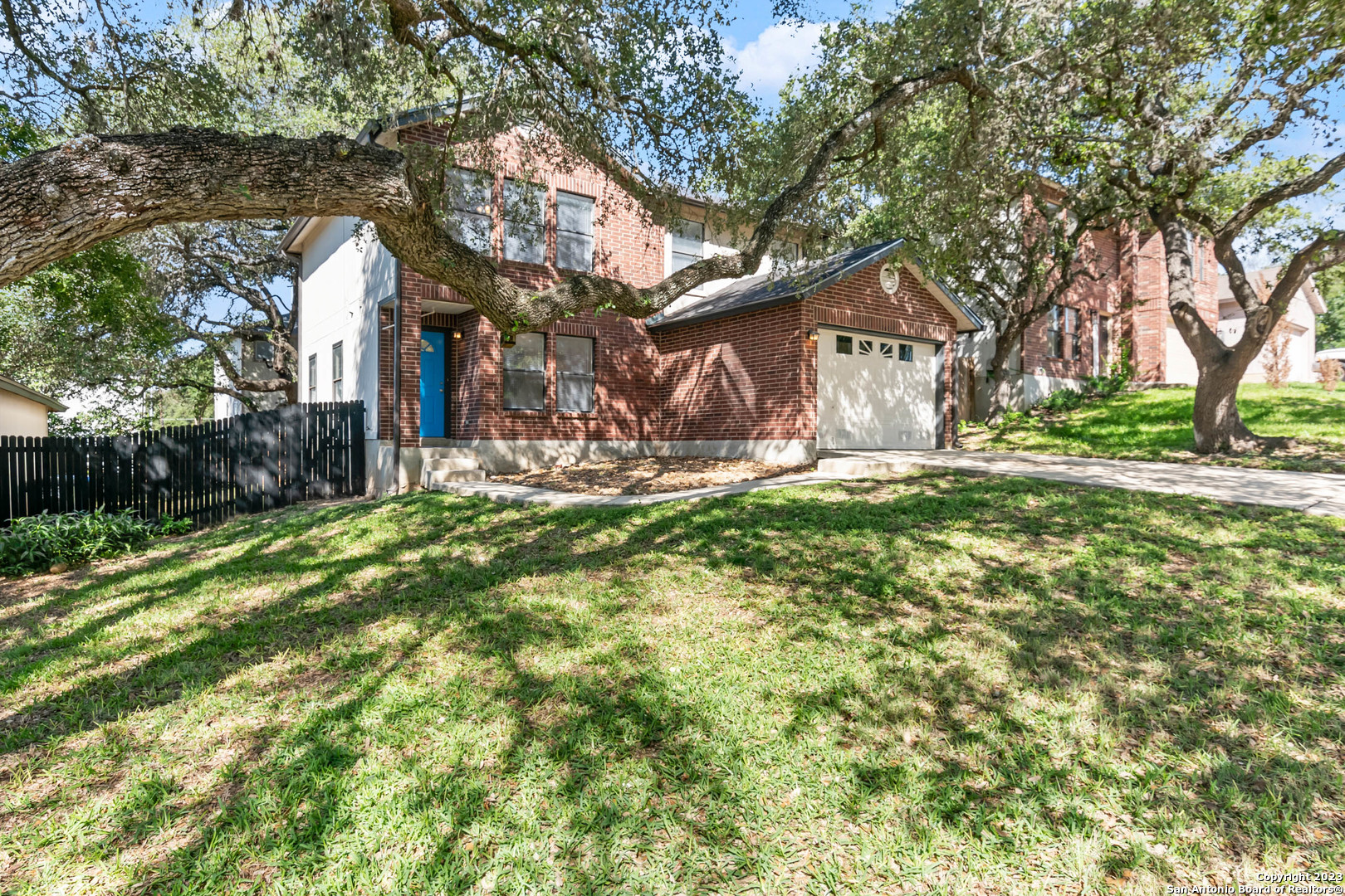 a backyard of a house with table and chairs