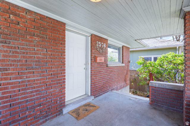 2576 Gramercy Avenue Ogden, UT 84401 - Photo 3 of 20 View of exterior entry featuring covered porch and brick siding